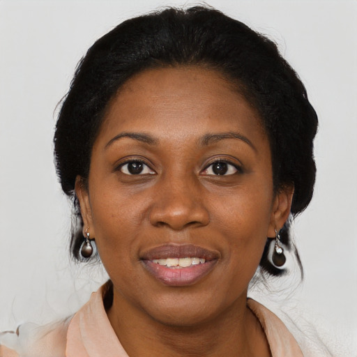 Joyful black adult female with medium  brown hair and brown eyes
