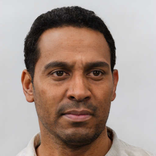 Neutral latino adult male with short  black hair and brown eyes