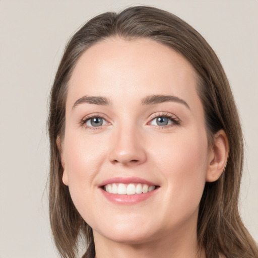 Joyful white young-adult female with long  brown hair and grey eyes