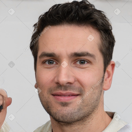 Joyful white young-adult male with short  brown hair and brown eyes