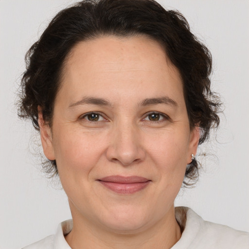 Joyful white adult female with medium  brown hair and brown eyes