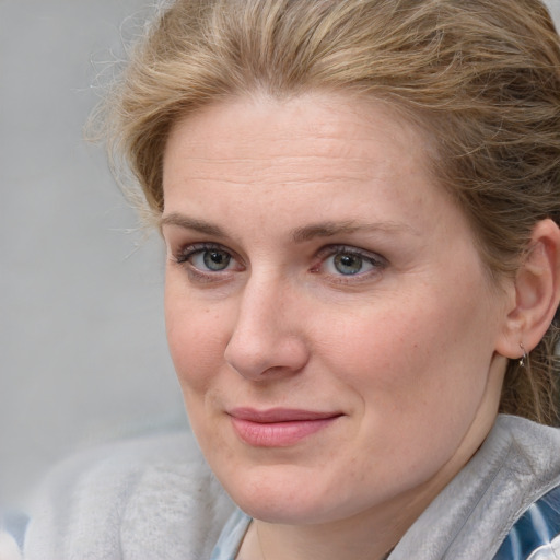 Joyful white young-adult female with medium  brown hair and blue eyes