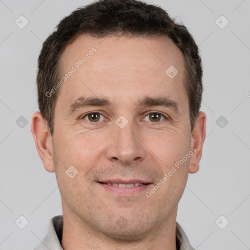 Joyful white adult male with short  brown hair and brown eyes