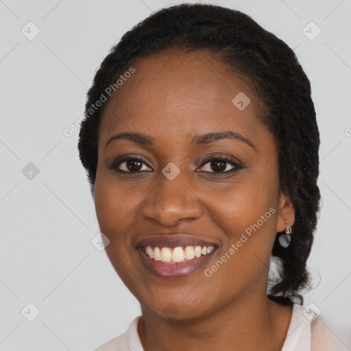 Joyful black young-adult female with long  black hair and brown eyes