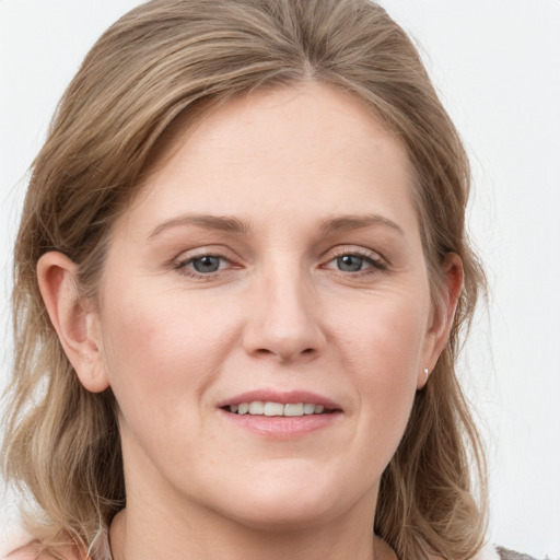 Joyful white young-adult female with medium  brown hair and blue eyes