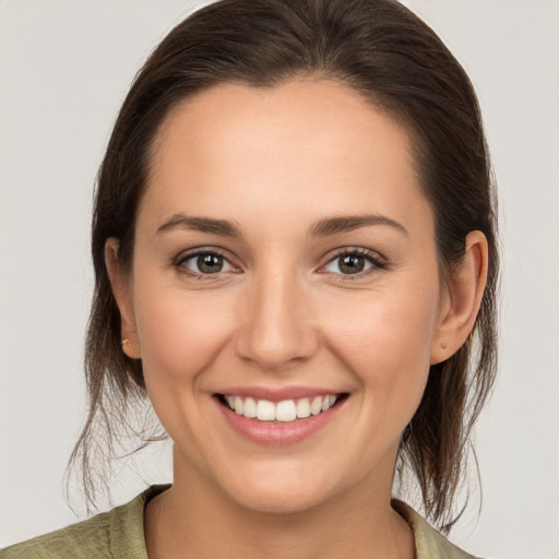 Joyful white young-adult female with medium  brown hair and brown eyes