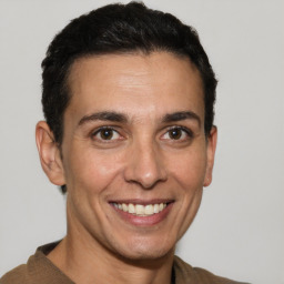 Joyful white adult male with short  brown hair and brown eyes