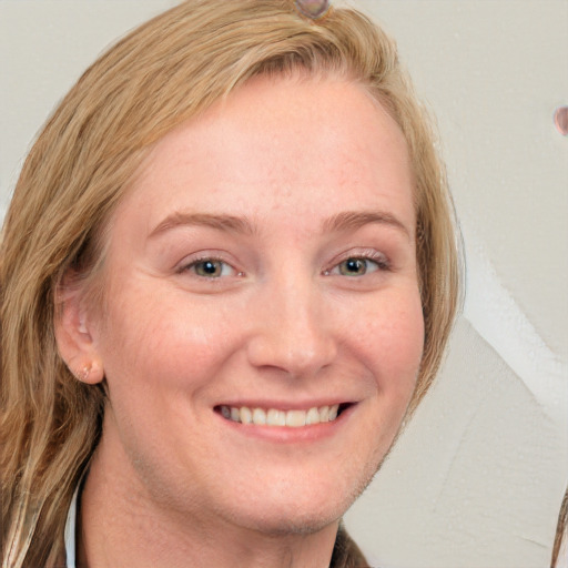 Joyful white young-adult female with long  brown hair and blue eyes