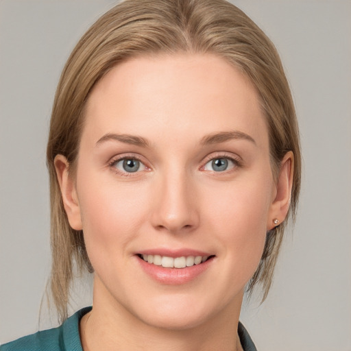 Joyful white young-adult female with medium  brown hair and blue eyes