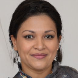 Joyful latino adult female with medium  brown hair and brown eyes