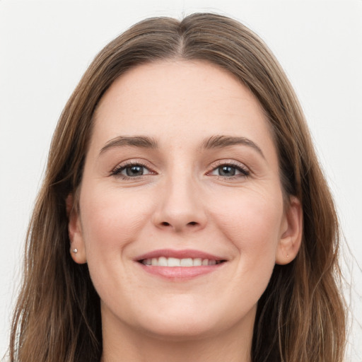 Joyful white young-adult female with long  brown hair and grey eyes