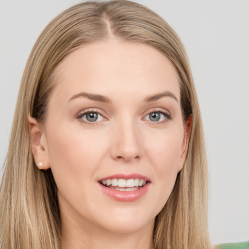 Joyful white young-adult female with long  brown hair and grey eyes