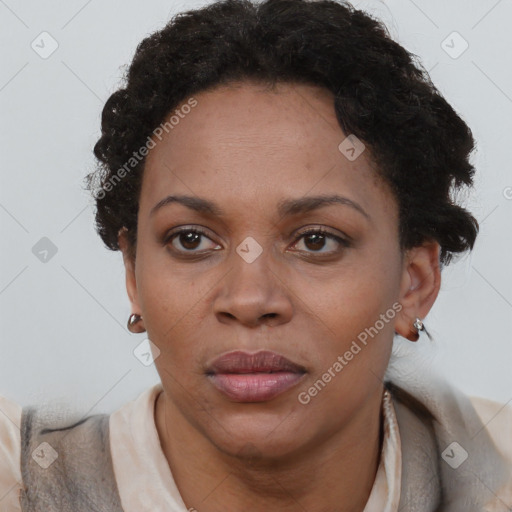 Joyful black adult female with short  brown hair and brown eyes