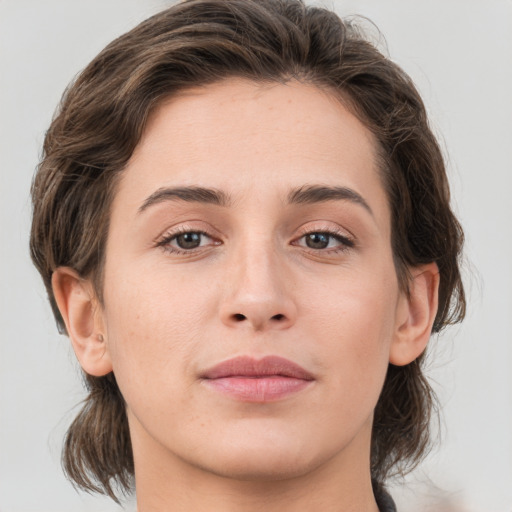 Joyful white young-adult female with medium  brown hair and brown eyes