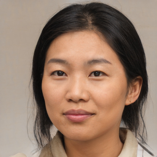Joyful asian young-adult female with medium  brown hair and brown eyes