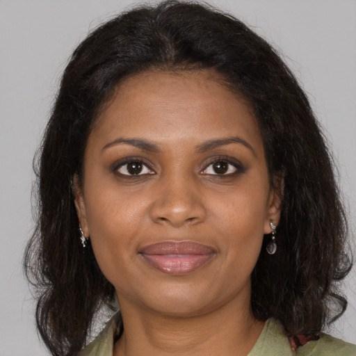 Joyful black young-adult female with medium  brown hair and brown eyes