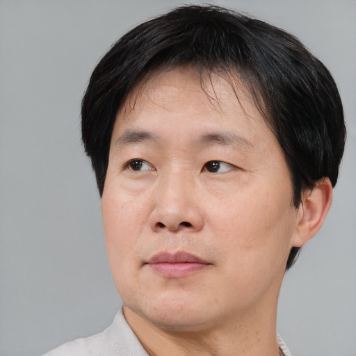 Neutral asian adult male with short  brown hair and brown eyes