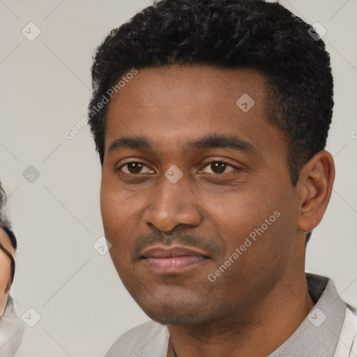 Neutral black young-adult male with short  black hair and brown eyes