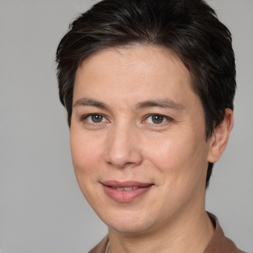 Joyful white adult female with short  brown hair and brown eyes