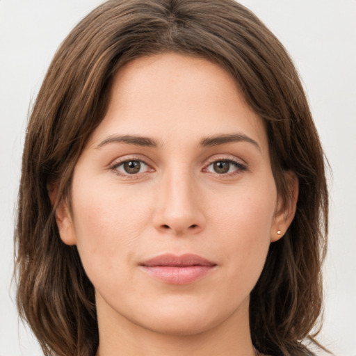 Joyful white young-adult female with long  brown hair and green eyes