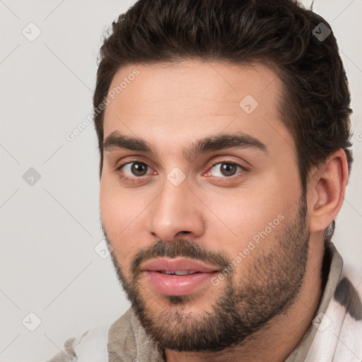 Joyful white young-adult male with short  brown hair and brown eyes