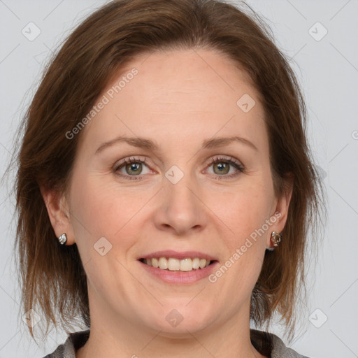 Joyful white adult female with medium  brown hair and grey eyes