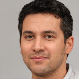 Joyful white adult male with short  brown hair and brown eyes