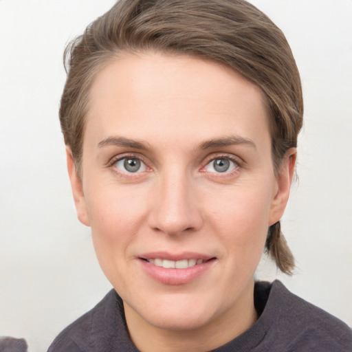 Joyful white young-adult female with short  brown hair and grey eyes