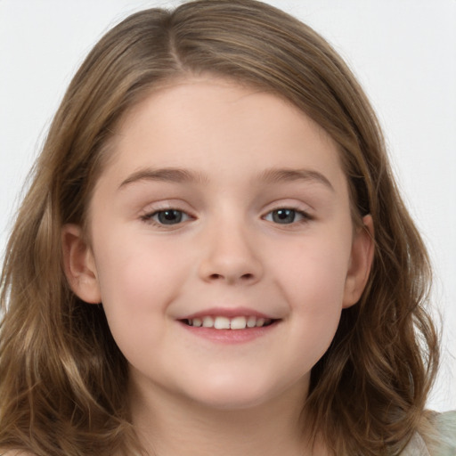 Joyful white child female with long  brown hair and brown eyes