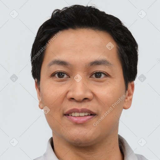 Joyful asian young-adult male with short  black hair and brown eyes