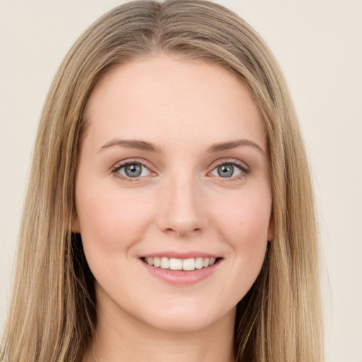 Joyful white young-adult female with long  brown hair and green eyes