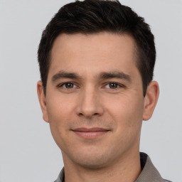 Joyful white young-adult male with short  brown hair and brown eyes