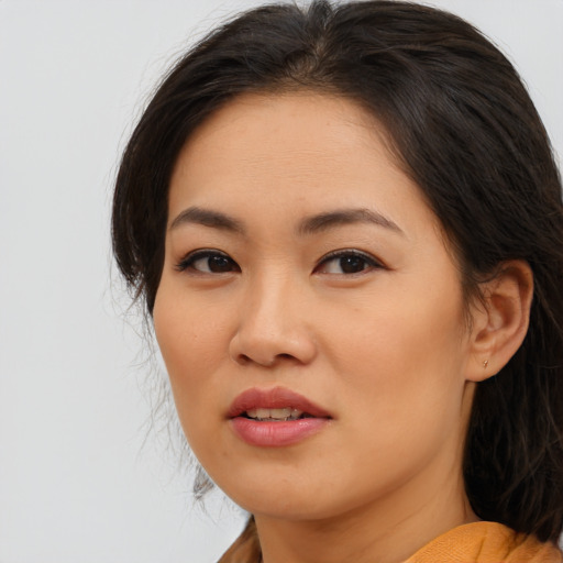 Joyful asian young-adult female with medium  brown hair and brown eyes