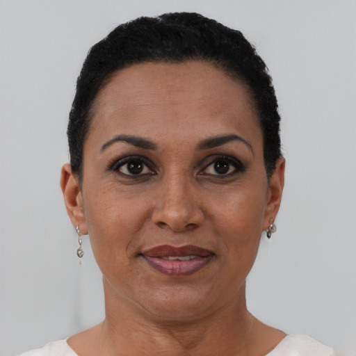 Joyful black adult female with short  black hair and brown eyes
