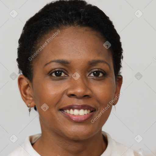 Joyful black young-adult female with short  brown hair and brown eyes