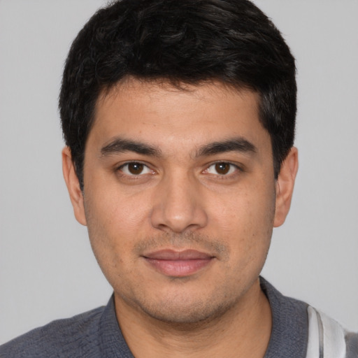 Joyful white young-adult male with short  black hair and brown eyes
