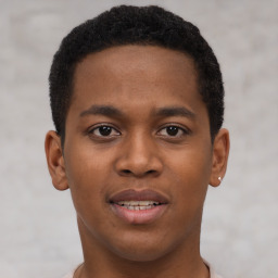 Joyful black young-adult male with short  brown hair and brown eyes