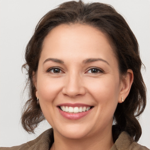 Joyful white young-adult female with medium  brown hair and brown eyes