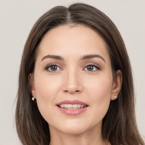 Joyful white young-adult female with long  brown hair and grey eyes