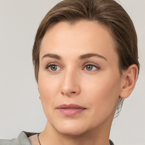 Joyful white young-adult female with medium  brown hair and grey eyes