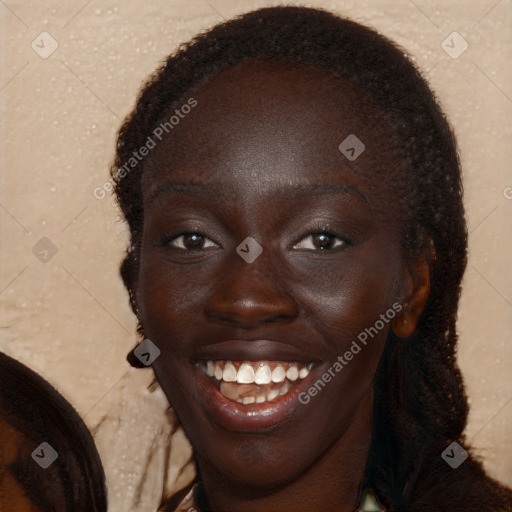 Joyful black young-adult female with long  brown hair and brown eyes