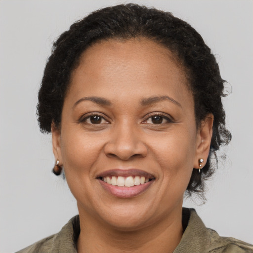 Joyful latino adult female with short  brown hair and brown eyes