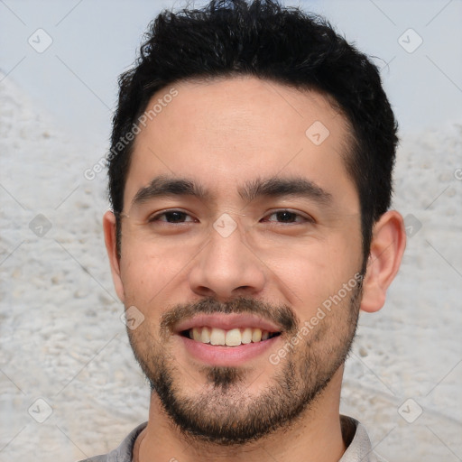 Joyful white young-adult male with short  black hair and brown eyes