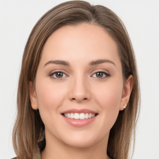 Joyful white young-adult female with long  brown hair and grey eyes