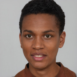 Joyful black young-adult male with short  brown hair and brown eyes