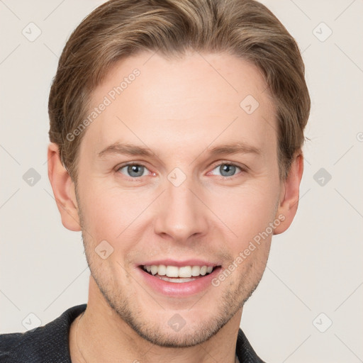 Joyful white young-adult male with short  brown hair and blue eyes