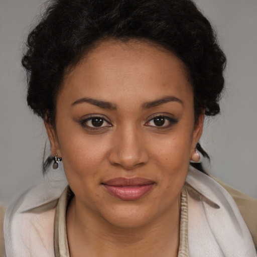 Joyful black young-adult female with short  brown hair and brown eyes