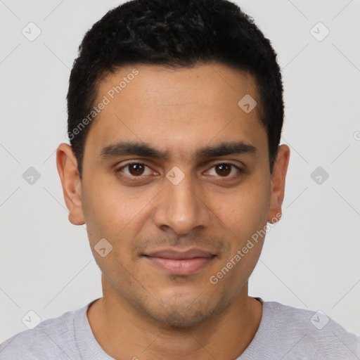 Joyful latino young-adult male with short  black hair and brown eyes