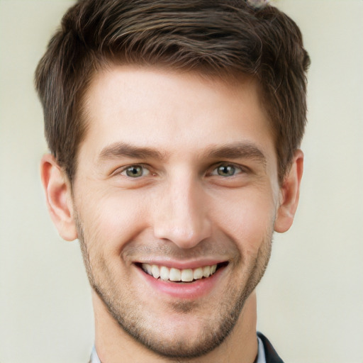 Joyful white young-adult male with short  brown hair and grey eyes