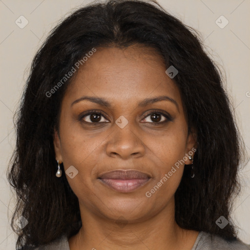 Joyful black adult female with long  brown hair and brown eyes